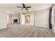 Large living room with fireplace and ceiling fan, perfect for relaxation and entertaining at 20830 Scenic Park Dr, Parker, CO 80138