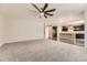 Spacious living area featuring plush carpeting, a ceiling fan, and a seamless transition to the modern kitchen at 20830 Scenic Park Dr, Parker, CO 80138