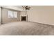 Spacious living room with a cozy fireplace and ceiling fan, perfect for relaxation and entertaining at 20830 Scenic Park Dr, Parker, CO 80138