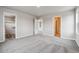 Bedroom featuring neutral walls, soft carpet, and walk-in closet with built-in storage solutions at 2267 Peregrine Dr, Brighton, CO 80601