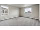 Bright bedroom features neutral walls, soft carpet, and large windows for ample natural light at 2267 Peregrine Dr, Brighton, CO 80601
