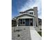 Charming two-story home featuring a modern gray color scheme and a cozy front porch at 2267 Peregrine Dr, Brighton, CO 80601