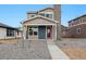 Charming two-story home with a blue and gray exterior, complemented by a well-maintained, xeriscaped front yard at 2267 Peregrine Dr, Brighton, CO 80601