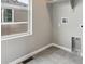 Well-lit laundry room featuring tile floor and access to water hookups at 2267 Peregrine Dr, Brighton, CO 80601