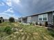 The backyard features a patio area, shrubs, and small trees at 6100 Bluestem # 238, Frederick, CO 80530