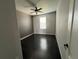 This bedroom features a ceiling fan, one window and dark hardwood floors at 6100 Bluestem # 238, Frederick, CO 80530