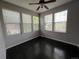 This bedroom features multiple windows providing natural light and dark hardwood floors at 6100 Bluestem # 238, Frederick, CO 80530