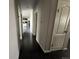 Hallway features doors to other rooms and dark hardwood floors at 6100 Bluestem # 238, Frederick, CO 80530