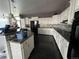 Bright kitchen with white cabinets, mosaic backsplash, and a center island for food prep at 6100 Bluestem # 238, Frederick, CO 80530