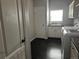 This laundry room features washer and dryer hookups, a sink and dark hardwood floors at 6100 Bluestem # 238, Frederick, CO 80530