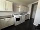 This laundry room features washer and dryer hookups, cabinets, and dark hardwood floors at 6100 Bluestem # 238, Frederick, CO 80530