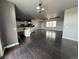Spacious open concept floor plan with dark wood floors and a large kitchen area at 6100 Bluestem # 238, Frederick, CO 80530