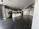 Spacious open concept floor plan with dark wood floors and a large kitchen area at 6100 Bluestem # 238, Frederick, CO 80530