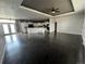 Open-concept living room with dark wood floors and tray ceiling adjacent to bright kitchen at 6100 Bluestem # 238, Frederick, CO 80530