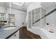 Bright bathroom featuring dual vanities, walk-in shower, and separate tub at 1940 Blake St # 300, Denver, CO 80202