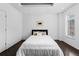 Bright bedroom with dark wood floors, a modern bed and plenty of natural light from the window at 1940 Blake St # 300, Denver, CO 80202