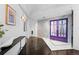 Inviting foyer with a colorful artistic wall and a purple door leading to the home at 1940 Blake St # 300, Denver, CO 80202