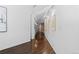 Bright hallway featuring pristine white walls, dark hardwood floors, and elegant artwork at 1940 Blake St # 300, Denver, CO 80202