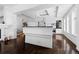 Bright kitchen with white cabinetry, island with dark countertop, and stainless steel appliances at 1940 Blake St # 300, Denver, CO 80202