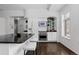 Open kitchen featuring a breakfast bar, white cabinets, stainless appliances, and wooden floors at 1940 Blake St # 300, Denver, CO 80202