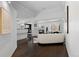 Open-concept living room with a cozy fireplace, white couch, and stylish decor elements at 1940 Blake St # 300, Denver, CO 80202