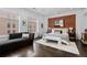 Stylish main bedroom with exposed brick, natural light, and a sitting area for relaxing at 1940 Blake St # 300, Denver, CO 80202