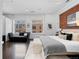 Bright main bedroom featuring a red brick accent wall and a comfortable seating area by the windows at 1940 Blake St # 300, Denver, CO 80202