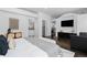 Bright main bedroom with an ensuite, a seating area, and a modern dresser with a decorative plant at 1940 Blake St # 300, Denver, CO 80202