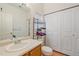 Bright bathroom featuring a single sink vanity, toilet, and closet for storage solutions at 14700 E 104Th Ave # 1602, Commerce City, CO 80022