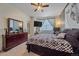 Comfortable bedroom featuring dark furniture, a ceiling fan, and neutral carpet at 14700 E 104Th Ave # 1602, Commerce City, CO 80022