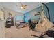 Bright bedroom with blue accent wall, hammock chair, and modern ceiling fan at 14700 E 104Th Ave # 1602, Commerce City, CO 80022