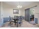 Cozy dining area with a stylish chandelier and access to the outdoor patio area at 14700 E 104Th Ave # 1602, Commerce City, CO 80022