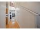 Bright hallway featuring hardwood floors and staircase leading to the upper level at 14700 E 104Th Ave # 1602, Commerce City, CO 80022