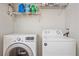 Efficient laundry room with a modern LG washer and Amana dryer, plus wire shelving at 14700 E 104Th Ave # 1602, Commerce City, CO 80022