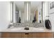 Double vanity sinks with modern lighting and faucet fixtures adorn this bright and elegant bathroom at 2100 16Th St # 606, Denver, CO 80202