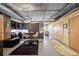 Open living area with concrete ceilings, desk area, and a view of the dining area at 2100 16Th St # 606, Denver, CO 80202