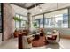 Contemporary sitting area with unique chairs, plants, and city views through expansive windows at 2100 16Th St # 606, Denver, CO 80202