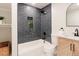 This bathroom features a tub, tiled shower, modern vanity with sleek black fixtures, a geometric cabinet and decor at 3728 W Exposition Ave, Denver, CO 80219
