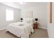 This bedroom features bright white decor, modern bedside tables, contemporary abstract art, and carpeted floors at 3728 W Exposition Ave, Denver, CO 80219
