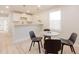 The eating area features white cabinets, quartz countertops, trendy lighting, a rug and gray seating at 3728 W Exposition Ave, Denver, CO 80219