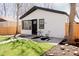 View of the home's exterior, highlighting the well-maintained lawn and modern black and white color scheme at 3728 W Exposition Ave, Denver, CO 80219