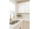 Bright kitchen features white cabinets, stainless appliances, quartz counters, and gold hardware at 3728 W Exposition Ave, Denver, CO 80219
