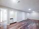 Finished basement with vinyl plank flooring, wet bar, and ample storage space at 11937 Claude Ct, Northglenn, CO 80233