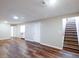 An expansive basement with wood-look vinyl floors and a staircase at 11937 Claude Ct, Northglenn, CO 80233
