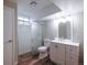 A well lit bathroom featuring a shower and vanity with matching hardware at 11937 Claude Ct, Northglenn, CO 80233