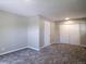 Bedroom featuring plush gray carpet, neutral walls, and a double door closet at 11937 Claude Ct, Northglenn, CO 80233