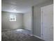 An empty bedroom offers neutral paint, new carpet, and a single window at 11937 Claude Ct, Northglenn, CO 80233