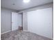 Neutral bedroom featuring a sliding door closet and access to additional rooms at 11937 Claude Ct, Northglenn, CO 80233