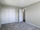 Bedroom featuring plush gray carpet, neutral walls, and a double door closet at 11937 Claude Ct, Northglenn, CO 80233