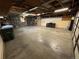 Spacious garage with ample storage space, shelving, and concrete flooring at 11937 Claude Ct, Northglenn, CO 80233
